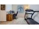 This home office features a wood desk, computer, chair, carpet, and a treadmill for fitness at 12578 Hudson Ct, Thornton, CO 80241