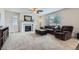 Comfortable living room featuring a fireplace, neutral carpet, and large windows at 12578 Hudson Ct, Thornton, CO 80241