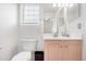 Cozy bathroom with neutral cabinets, a toilet, and a sink, providing a private space for personal care routines at 20835 E 47Th Ave, Denver, CO 80249