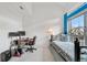 Bright bedroom with a large window, work space, blue accents, and comfortable bed, perfect for work or relaxation at 20835 E 47Th Ave, Denver, CO 80249