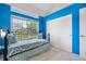 Stylish bedroom featuring blue accent walls, a comfortable bed, and a window with a view, creating a relaxing retreat at 20835 E 47Th Ave, Denver, CO 80249