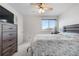 Comfortable bedroom with a dresser, bed, and a window, offering a relaxing and serene atmosphere for restful nights at 20835 E 47Th Ave, Denver, CO 80249