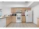 Functional kitchen featuring neutral cabinets, white appliances, and tiled floors, providing a clean and practical cooking space at 20835 E 47Th Ave, Denver, CO 80249