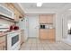Well-lit kitchen with ample counter space, white appliances, and neutral cabinetry, offering a practical cooking environment at 20835 E 47Th Ave, Denver, CO 80249