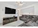 Spacious living room with a fireplace, large TV, and comfortable seating area at 20835 E 47Th Ave, Denver, CO 80249