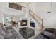Bright living area featuring high ceilings, cozy fireplace, plush sofas, and an adjacent dining area at 20835 E 47Th Ave, Denver, CO 80249