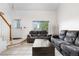 Cozy living room featuring plush sofas, tile flooring, a fireplace, and ample natural light at 20835 E 47Th Ave, Denver, CO 80249