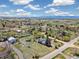 Aerial view of a neighborhood showcasing homes, spacious lots, and mountain views in the distance at 1866 Mountain View St, Erie, CO 80516