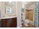 Bathroom with marble-look vanity and tiled shower/bath combo with curtain at 1866 Mountain View St, Erie, CO 80516