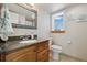 Bright bathroom featuring granite countertop vanity, and a scenic window at 1866 Mountain View St, Erie, CO 80516