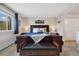 Comfortable bedroom with dark wood furnishings and mountain themed art at 1866 Mountain View St, Erie, CO 80516