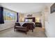 Comfortable bedroom with view, complete with a bench, bedside tables and decorative mountain painting at 1866 Mountain View St, Erie, CO 80516