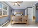Comfortable bedroom featuring modern ceiling fan, blue LED trim and tiled flooring at 1866 Mountain View St, Erie, CO 80516