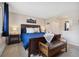 Comfortable primary bedroom featuring a large window, dark furniture and mountain themed art at 1866 Mountain View St, Erie, CO 80516