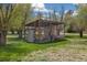 Rustic wooden chicken coop with secure enclosure and access door surrounded by greenery at 1866 Mountain View St, Erie, CO 80516