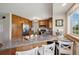 Charming kitchen boasts countertops with bar seating and modern stainless steel appliances at 1866 Mountain View St, Erie, CO 80516