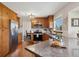 Bright kitchen with stainless appliances, wood cabinets and flooring plus a view to the dining area at 1866 Mountain View St, Erie, CO 80516