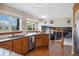 Cozy kitchen boasts light wood cabinetry, lots of natural light, and views of the living room at 1866 Mountain View St, Erie, CO 80516