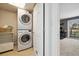 Convenient laundry area with stacked washer and dryer, plus storage at 1866 Mountain View St, Erie, CO 80516