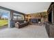 Spacious living room featuring a stone fireplace and a walkout to the yard at 1866 Mountain View St, Erie, CO 80516