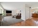 Spacious living room featuring hardwood floors, cozy carpet, and a large entertainment center at 1866 Mountain View St, Erie, CO 80516