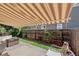 Shaded patio with outdoor seating and well-maintained artificial grass at 4720 S Dudley St # 38, Littleton, CO 80123