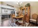 Dining room featuring a wooden table set for four, a wooden hutch and view of a kitchen with gray cabinets at 4720 S Dudley St # 38, Littleton, CO 80123