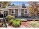 Charming home featuring stone siding, a landscaped yard with rock and wood details, and a white front door at 4720 S Dudley St # 38, Littleton, CO 80123