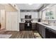 Modern kitchen featuring gray and white cabinets, stainless steel appliances, a mosaic backsplash and wood flooring at 4720 S Dudley St # 38, Littleton, CO 80123