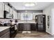 Modern kitchen featuring gray and white cabinets, updated appliances, a mosaic backsplash and wood flooring at 4720 S Dudley St # 38, Littleton, CO 80123