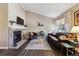 Bright living room with high ceilings, a stone fireplace, hardwood floors, and a comfortable leather sofa and arm chair at 4720 S Dudley St # 38, Littleton, CO 80123