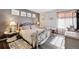 Cozy bedroom featuring a decorative iron bed, neutral walls, wood flooring and a window with natural light at 4720 S Dudley St # 38, Littleton, CO 80123