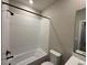 Clean bathroom with a bathtub and white tile at 9444 Yampa St, Commerce City, CO 80022