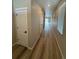 Bright hallway with wood-look floors and neutral walls at 9444 Yampa St, Commerce City, CO 80022