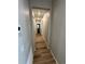 Long hallway with light walls and wood-look flooring at 9444 Yampa St, Commerce City, CO 80022