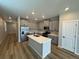 Modern kitchen with island, stainless steel appliances, and light gray cabinets at 9444 Yampa St, Commerce City, CO 80022