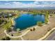 Scenic aerial view of a tranquil lake surrounded by walking paths, lush greenery, and charming residential neighborhoods at 420 Graham Cir, Erie, CO 80516