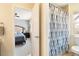 Bright bathroom with a shower-tub combination featuring a stylish blue patterned shower curtain at 420 Graham Cir, Erie, CO 80516