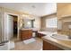 Spacious bathroom with double sinks, cabinets, tile floor, soaking tub, and walk in closet at 420 Graham Cir, Erie, CO 80516