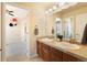 Clean and well-lit bathroom with double sinks, wood cabinets, and a neutral color scheme at 420 Graham Cir, Erie, CO 80516