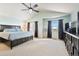 Large primary bedroom with tray ceiling, big windows, and plenty of space at 420 Graham Cir, Erie, CO 80516