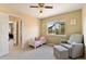 Cozy bedroom with a window, comfortable seating, and bright natural light at 420 Graham Cir, Erie, CO 80516