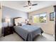 Comfortable bedroom with a large window, neutral carpet, and a ceiling fan at 420 Graham Cir, Erie, CO 80516