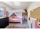 Adorable bedroom with pink accents, canopy bed, and plenty of storage at 420 Graham Cir, Erie, CO 80516