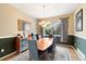 Elegant dining room featuring chair railing, wooden table, and stylish chandelier at 420 Graham Cir, Erie, CO 80516