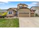 A charming two-story home with a well-manicured lawn and a spacious two-car garage at 420 Graham Cir, Erie, CO 80516