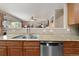 Modern kitchen featuring stainless steel appliances, stone countertops, and wood cabinets at 420 Graham Cir, Erie, CO 80516