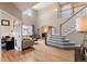 Bright living room showcasing high ceilings, hardwood floors, and a staircase at 420 Graham Cir, Erie, CO 80516