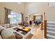 Inviting living room open to dining area, filled with natural light and stylish furniture at 420 Graham Cir, Erie, CO 80516