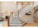 Elegant staircase features carpeted steps and painted white risers and wood trim at 420 Graham Cir, Erie, CO 80516